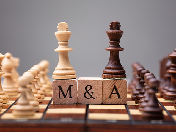 Chess pieces denoting the merger of two companies